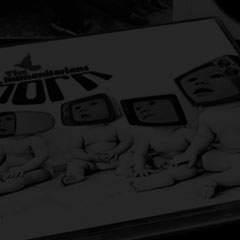 CD cover and insert for The Humanitarians showing cover image of babies with their faces trapped inside TV sets.